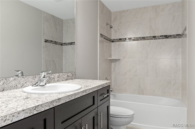 full bathroom featuring vanity, toilet, and tiled shower / bath combo