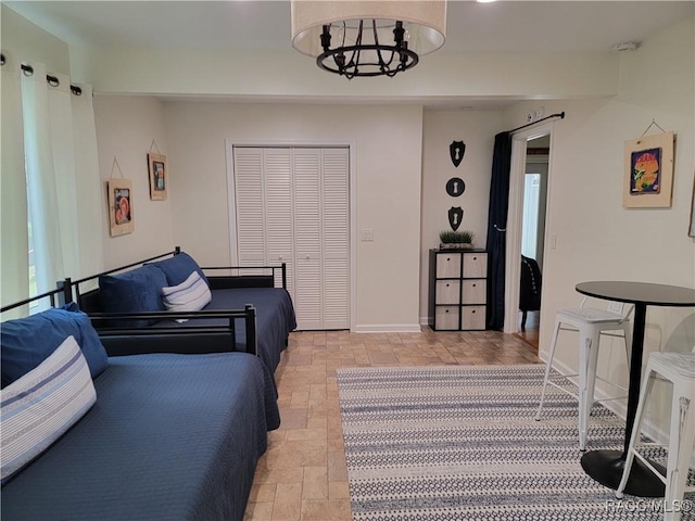 20165 SE 115th Ave, Inglis, FL 34449 - living area featuring stone tile floors, a chandelier, and baseboards