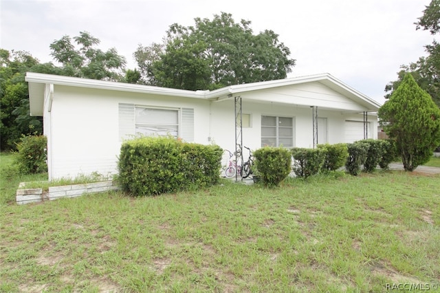 view of side of home with a yard