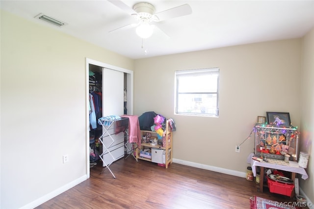 bedroom with ceiling fan, a closet, and dark wood-type flooring