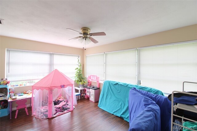 interior space with ceiling fan and dark wood-type flooring