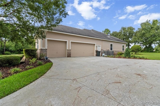 3915 N Grayhawk Loop, Lecanto, FL 34461 - view of home's exterior with concrete driveway, an attached garage, stucco siding, and a tile roof