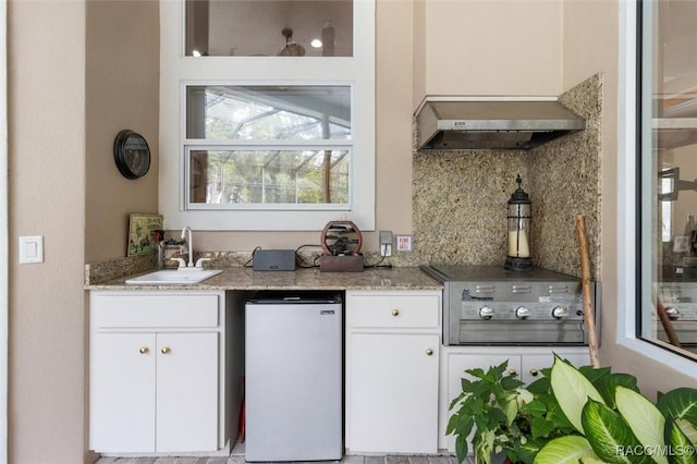 3915 N Grayhawk Loop, Lecanto, FL 34461 - kitchen featuring fridge, tasteful backsplash, white cabinets, and light stone counters