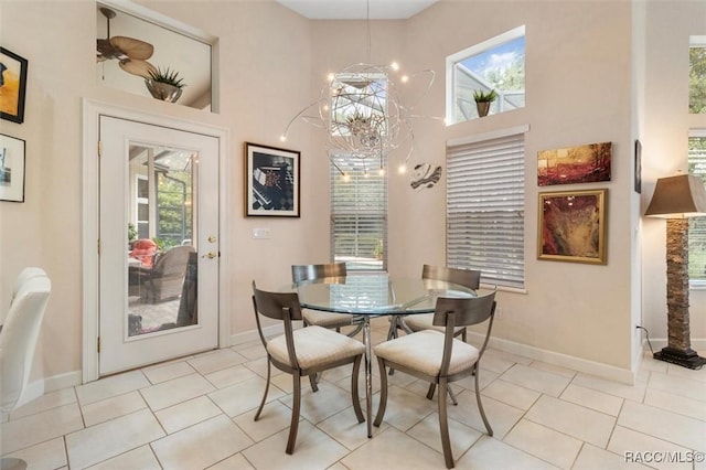 3915 N Grayhawk Loop, Lecanto, FL 34461 - dining room featuring plenty of natural light, a high ceiling, light tile patterned floors, and a chandelier