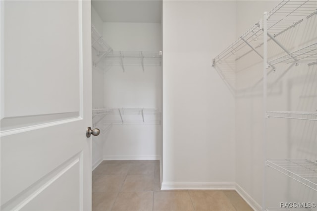 walk in closet featuring light tile patterned floors