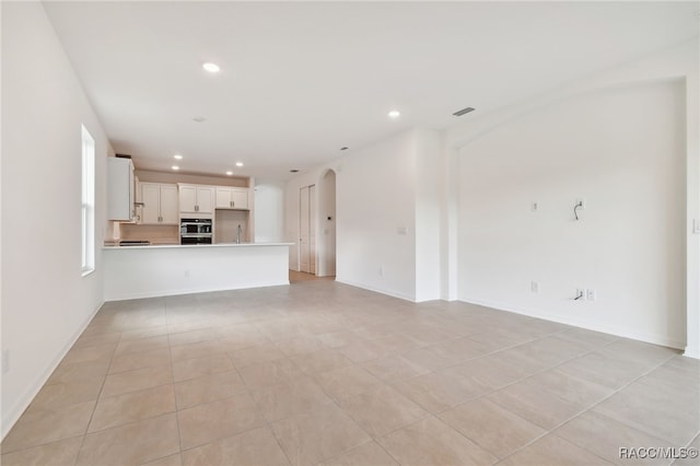 unfurnished living room with light tile patterned flooring