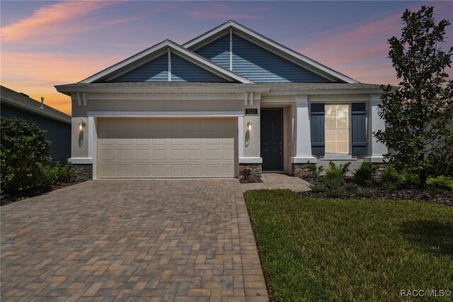 view of front facade featuring a garage and a front lawn