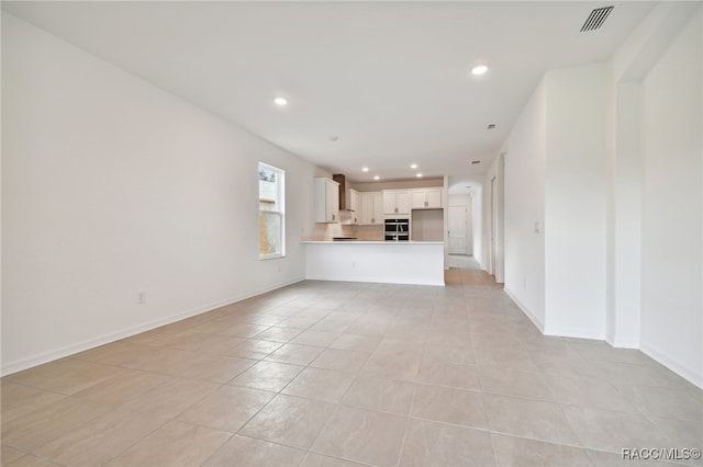 unfurnished living room with light tile patterned flooring