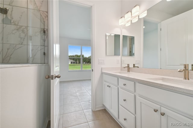 bathroom featuring vanity, tile patterned floors, and tiled shower