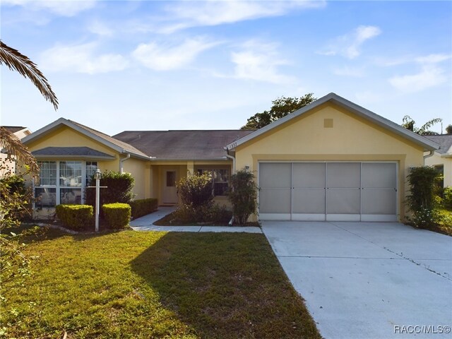 single story home with a garage and a front yard