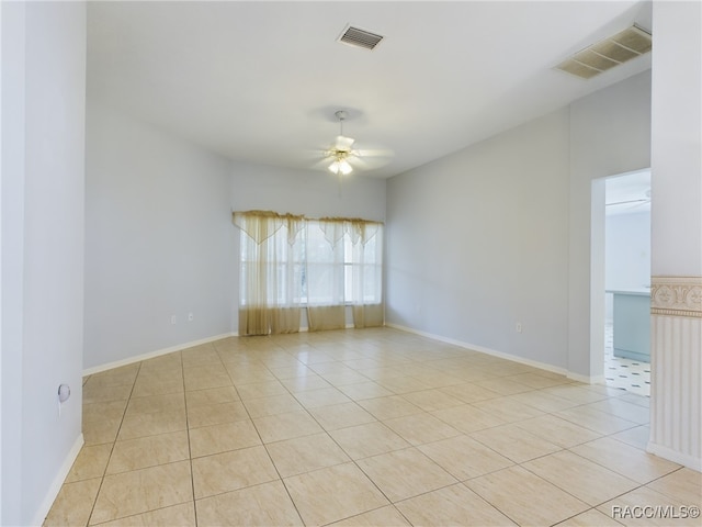 unfurnished room with ceiling fan and light tile patterned floors