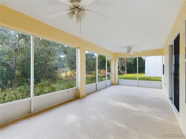 unfurnished sunroom featuring ceiling fan