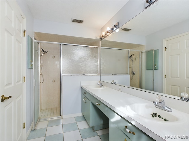 bathroom featuring tile patterned flooring, vanity, and an enclosed shower