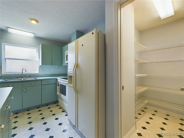 kitchen with white appliances, sink, and tasteful backsplash