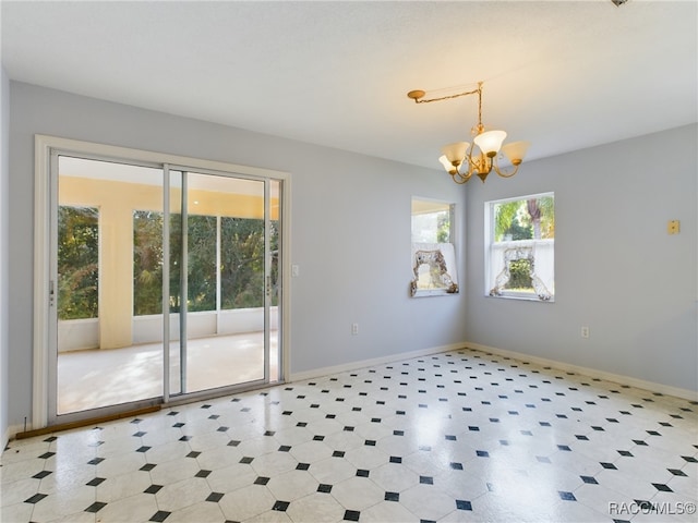 spare room with a notable chandelier