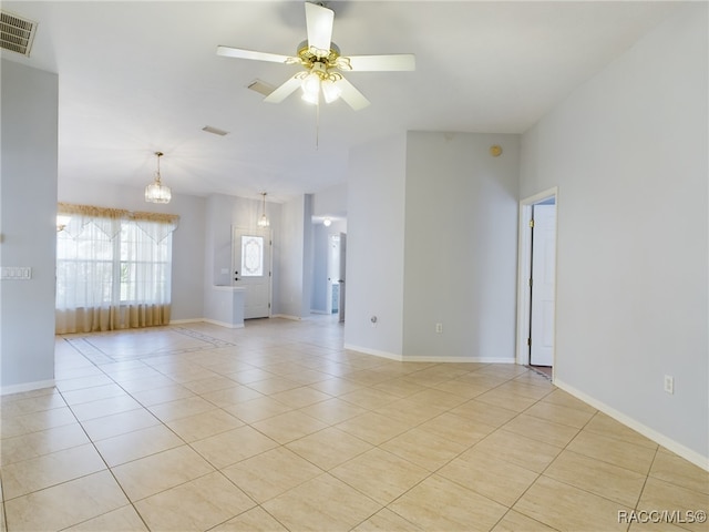 unfurnished room with light tile patterned floors and ceiling fan with notable chandelier