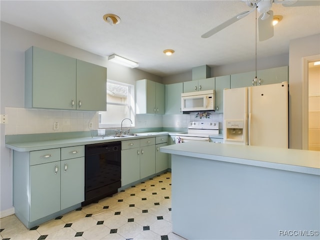 kitchen featuring white appliances, tasteful backsplash, green cabinets, and sink