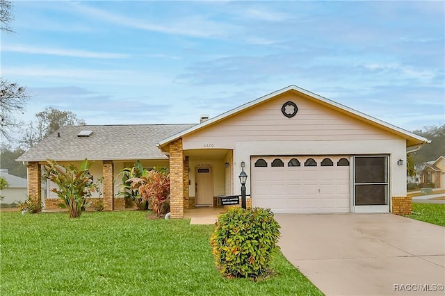 ranch-style house with a garage and a front lawn