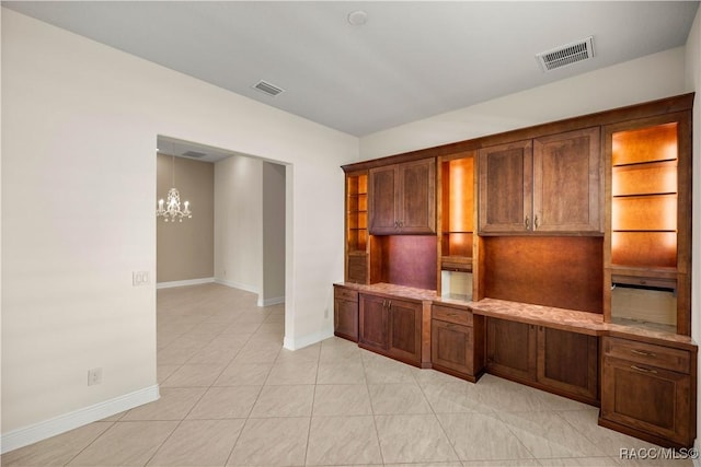 unfurnished office featuring light tile patterned floors and a notable chandelier