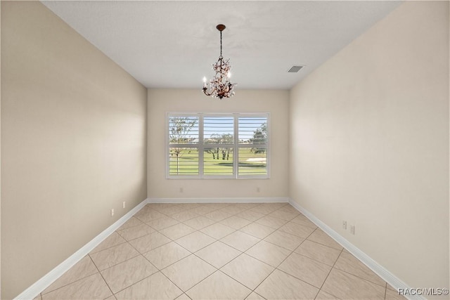 unfurnished room featuring a chandelier