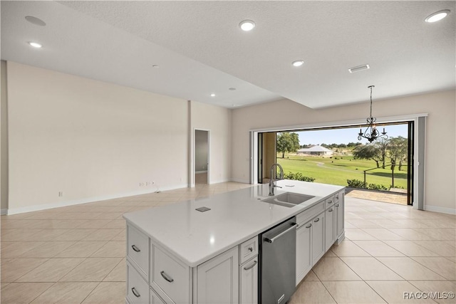 kitchen with light tile patterned floors, sink, dishwasher, white cabinets, and a center island with sink