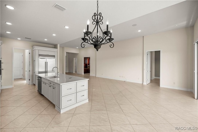 kitchen featuring stainless steel appliances, an island with sink, light tile patterned flooring, and white cabinets