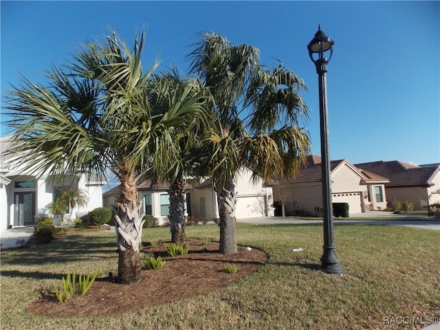 view of front of house featuring a garage and a front lawn