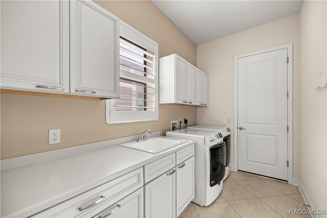 laundry area with cabinets, light tile patterned flooring, sink, and independent washer and dryer