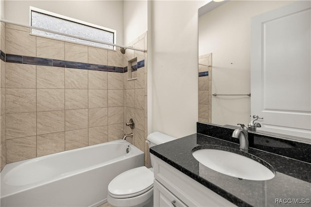 full bathroom with vanity, toilet, and tiled shower / bath