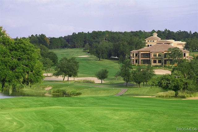 surrounding community with a lawn and a water view