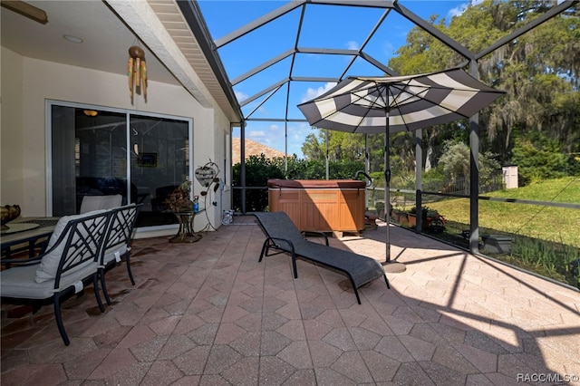 view of patio / terrace featuring a lanai and a hot tub