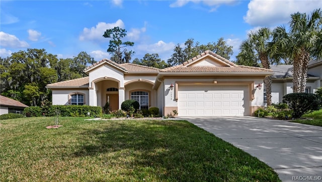 mediterranean / spanish-style house with a front lawn and a garage