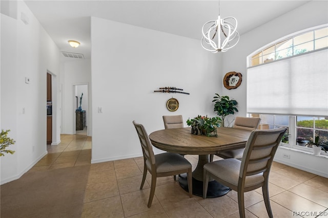 dining room featuring a chandelier and light tile patterned flooring