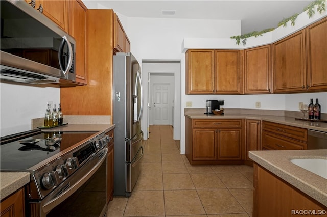 kitchen featuring light tile patterned floors and appliances with stainless steel finishes