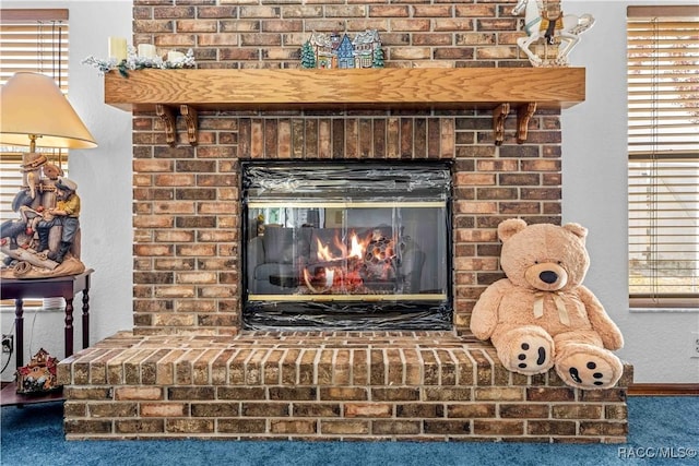 interior details with a fireplace and carpet