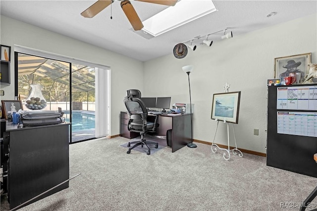 carpeted home office featuring rail lighting and ceiling fan