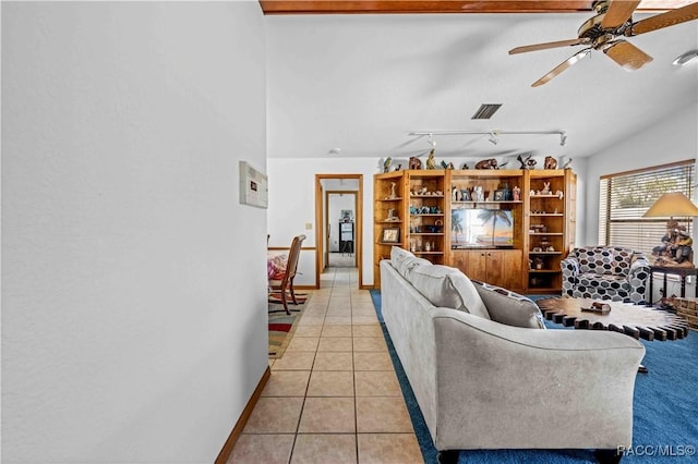 tiled living room featuring ceiling fan and track lighting