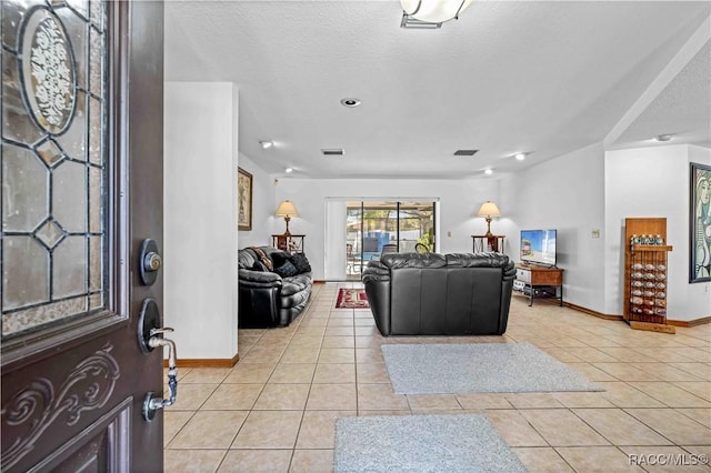 tiled living room with a textured ceiling