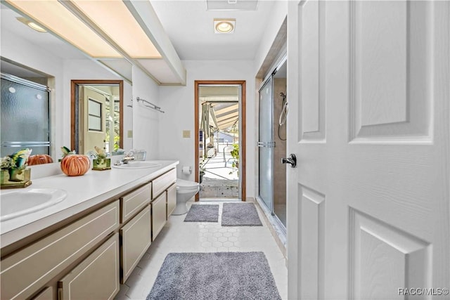 bathroom featuring toilet, vanity, and walk in shower