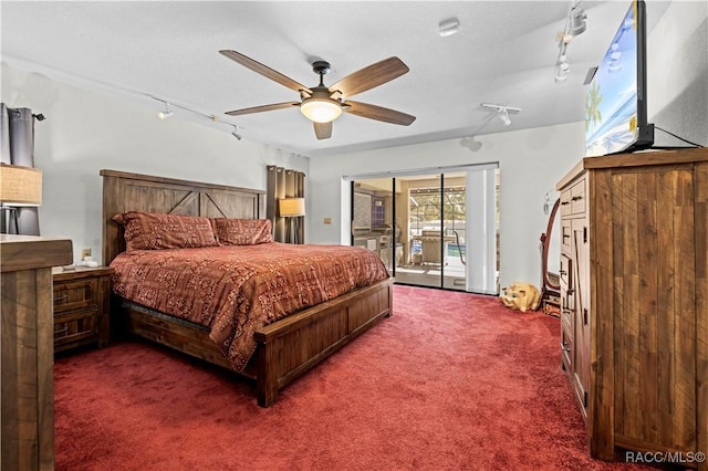 bedroom with ceiling fan, access to exterior, rail lighting, and dark colored carpet