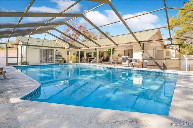 view of swimming pool with area for grilling, a lanai, and a patio