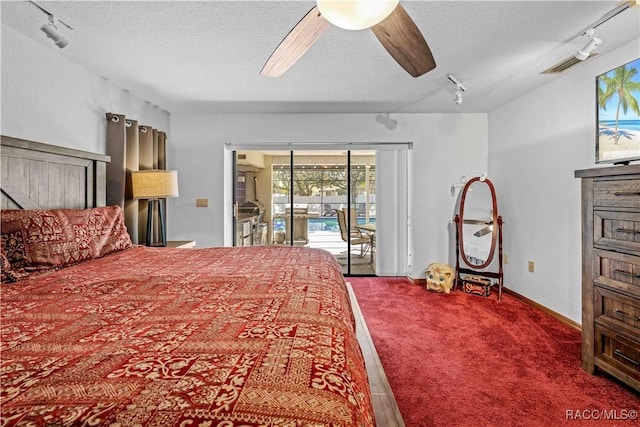 bedroom with a textured ceiling, track lighting, ceiling fan, access to exterior, and carpet