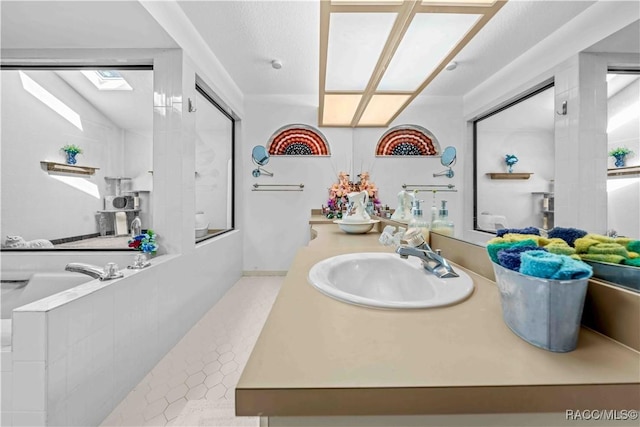 bathroom featuring vanity, a textured ceiling, tile patterned floors, and separate shower and tub