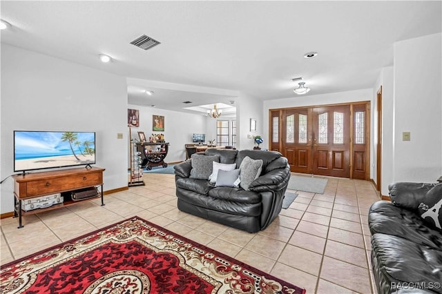 living room featuring light tile patterned floors and a chandelier