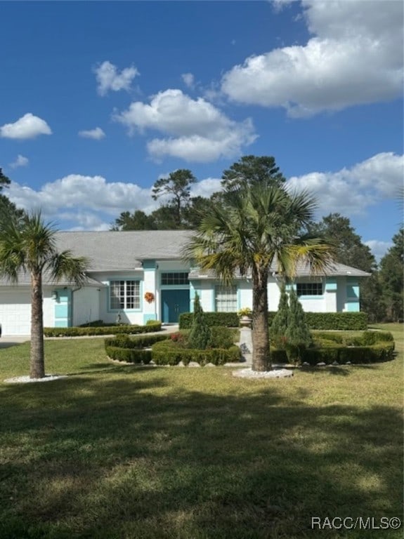 view of front facade with a front lawn and a garage