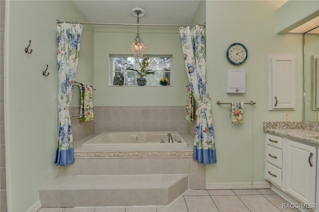 bathroom with vanity, tile patterned floors, and tiled tub