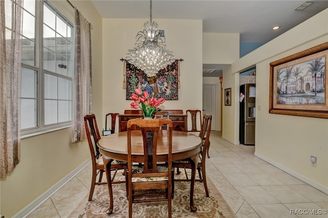 dining room featuring light tile patterned floors and a notable chandelier