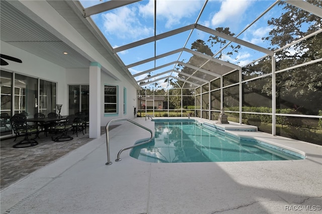 view of swimming pool with a lanai and a patio area