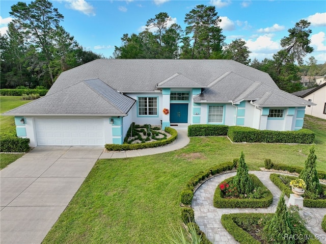 ranch-style house featuring a front yard and a garage