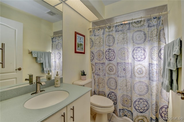 bathroom featuring a shower with curtain, tile patterned flooring, vanity, and toilet